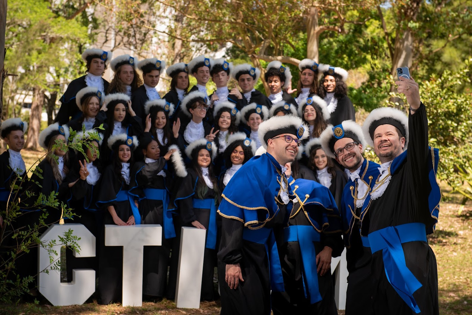 A class of students in graduation outfit.